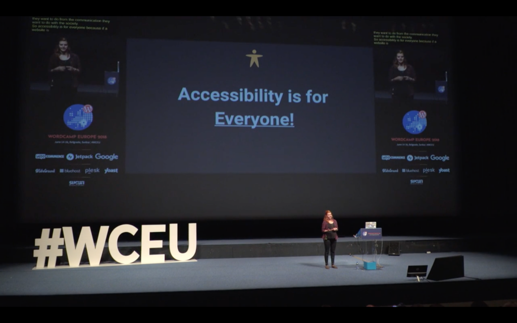 Me on stage giving a talk. The Slide says: "Accessibility is for Everyone". Next to it is the transcription text and the Logo of WordCamp Europe. At stage are big letters with #WCEU